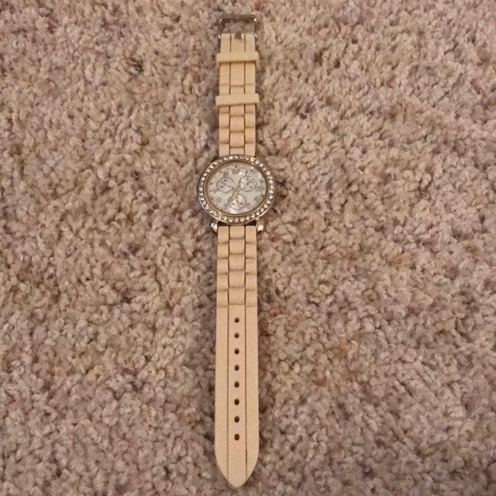 Cream and gold watch with gem watch face